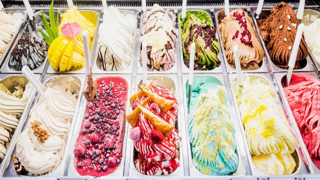 A freezer full of tubs containing a variety of flavors of gelato A freezer full of tubs containing a variety of flavors of gelato