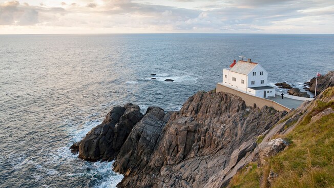 A building on a rocky cliff overlooking the ocean