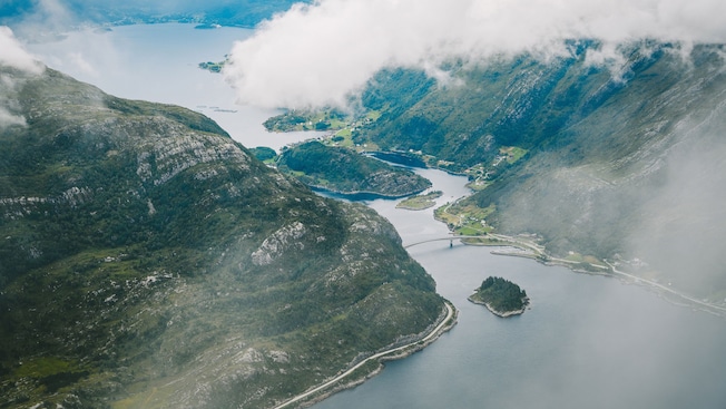 Large mountains with a body of water running between them Large mountains with a body of water running between them