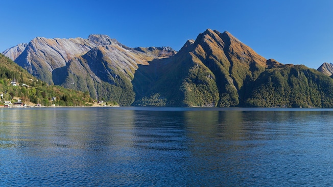 A fjord surrounded by wooded mountains A fjord surrounded by wooded mountains