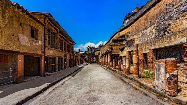 An empty street lined with ancient Roman ruins