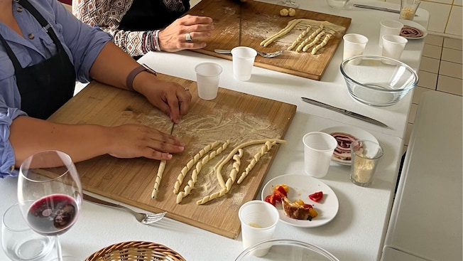 Two people making pasta noodles in a cooking class in Gragnano, Italy Two people making pasta noodles in a cooking class in Gragnano, Italy