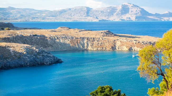 Rocky cliffs at Saint Paul’s Bay in Rhodes, Greece