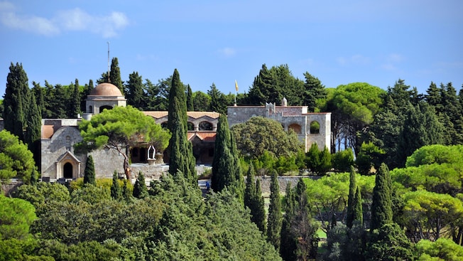 The Filerimos Monastery nestled among cypress and pine trees on Mount Filerimos in Rhodes, Greece The Filerimos Monastery nestled among cypress and pine trees on Mount Filerimos in Rhodes, Greece