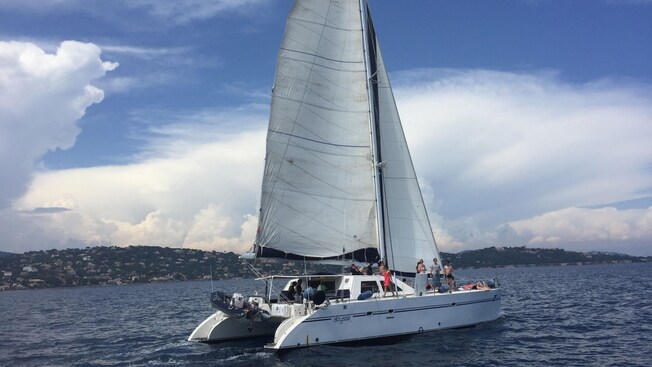 A catamaran sailing across the sea