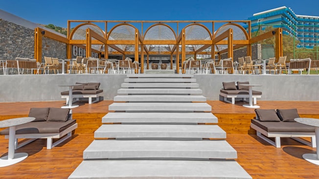 A patio with chairs and tables at Naya Beach Bar & Restaurant in Faliraki, Greece A patio with chairs and tables at Naya Beach Bar & Restaurant in Faliraki, Greece