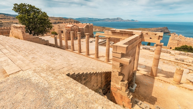 Ancient stone columns standing at the bottom of steps