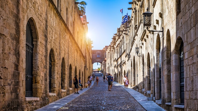 A cobblestone street lined with stone buildings in Rhodes Old Town