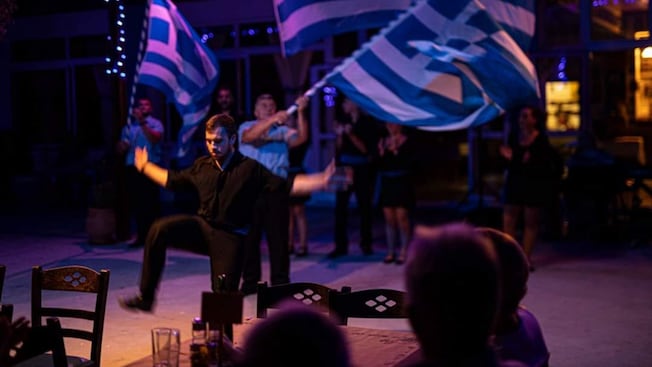 Guests watching a live dance performance at the Taverna Mimakos in Rhodes, Greece Guests watching a live dance performance at the Taverna Mimakos in Rhodes, Greece