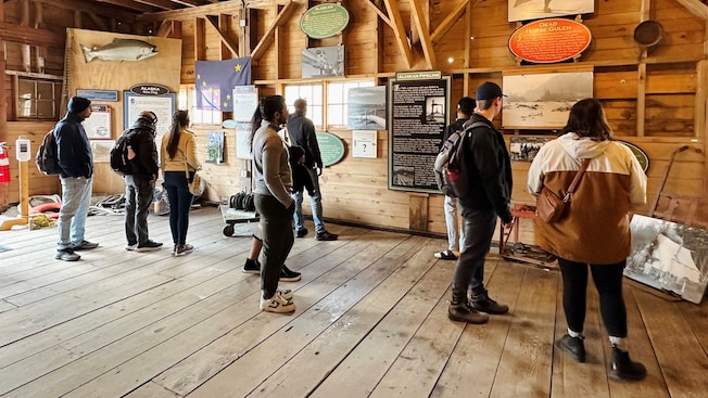 Guests looking at an exhibit in the Icy Strait Museum Guests looking at an exhibit in the Icy Strait Museum