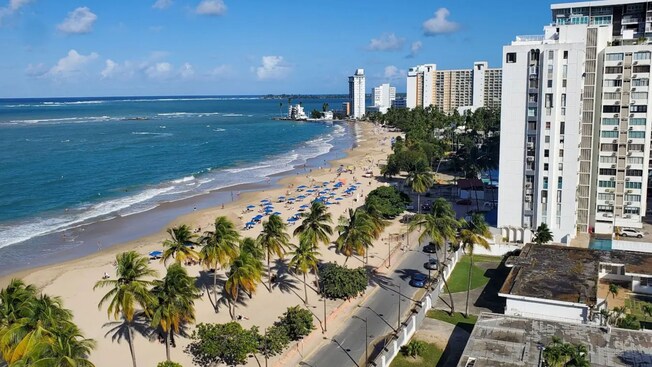 High rise buildings lining the street near the beach and shoreline of San Juan, Puerto Rico