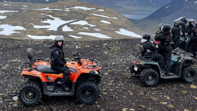 A group of all terrain vehicle riders exploring a rugged mountain pass