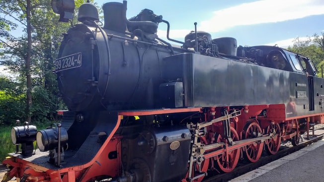 A steam train parked on the tracks A steam train parked on the tracks