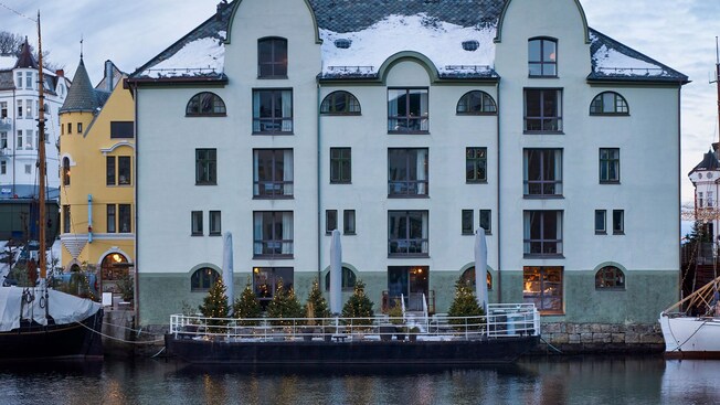 The lake view of Hotel Brosundet decorated with holiday lights in Ålesund, Norway