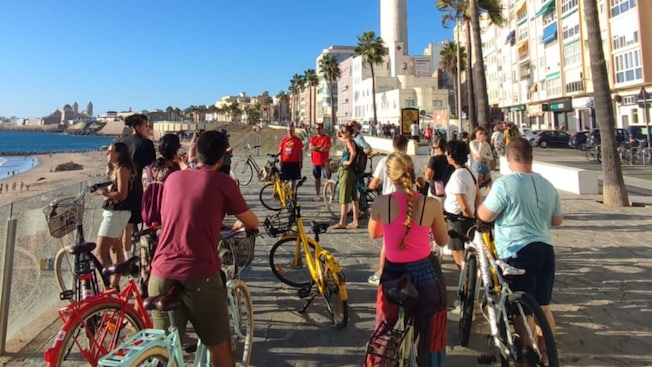 A group of people on bicycles near the seaside in Cadiz, Spain A group of people on bicycles near the seaside in Cadiz, Spain
