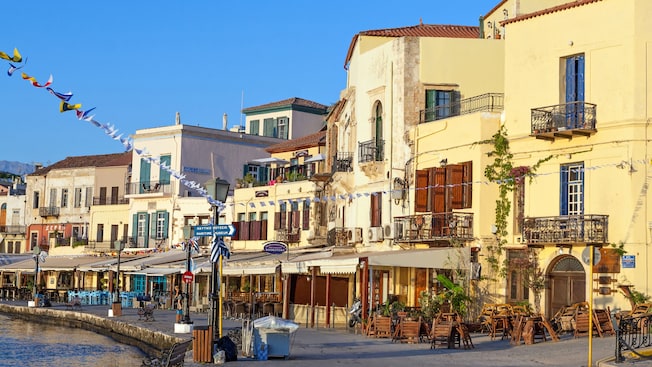 Houses and cafés along a waterfront promenade in Chania, Greece Houses and cafés along a waterfront promenade in Chania, Greece