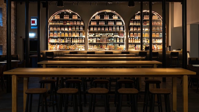 A lighted bar with stools, tables, chairs and hundreds of Jameson Irish Whiskey products A lighted bar with stools, tables, chairs and hundreds of Jameson Irish Whiskey products