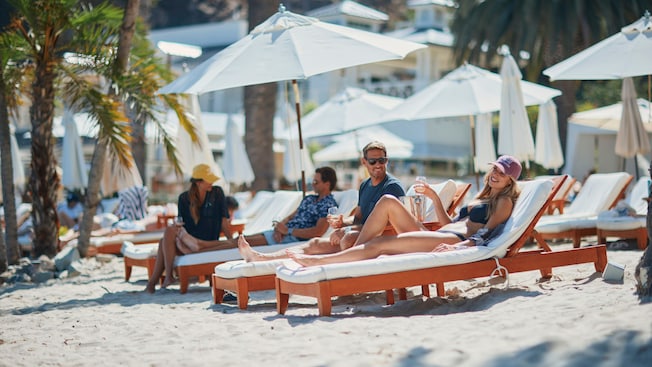 Guests relaxing on loungers at Descanso Beach Club Guests relaxing on loungers at Descanso Beach Club