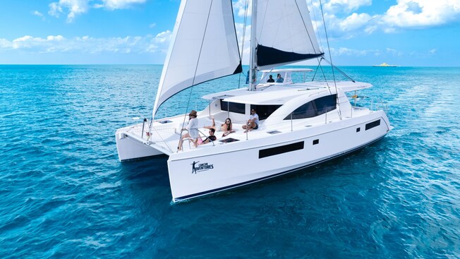 A catamaran sails on a calm ocean
