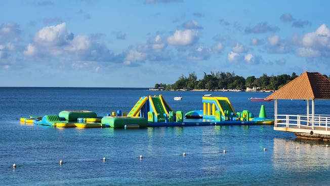 An inflatable floating playground in the waters of a shallow beach An inflatable floating playground in the waters of a shallow beach