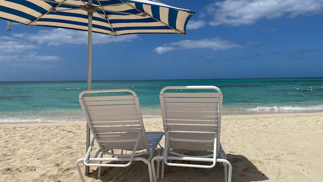Two chairs and an umbrella on a beach in Falmouth, Jamaica Two chairs and an umbrella on a beach in Falmouth, Jamaica