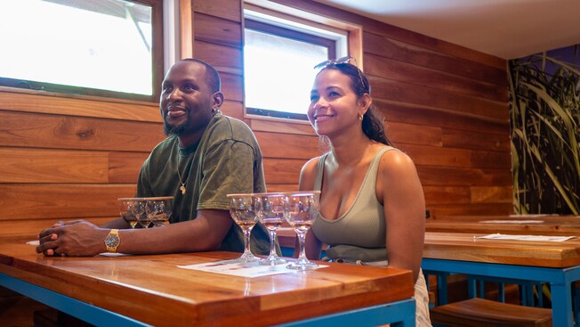 A couple at a table tasting different drinks