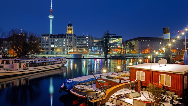 Boats in a river with the Berlin TV Tower in the distance Boats in a river with the Berlin TV Tower in the distance