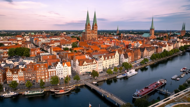 A mixture of historical churches with spires and gabled buildings in the lakefront city of Hamburg, Germany A mixture of historical churches with spires and gabled buildings in the lakefront city of Hamburg, Germany