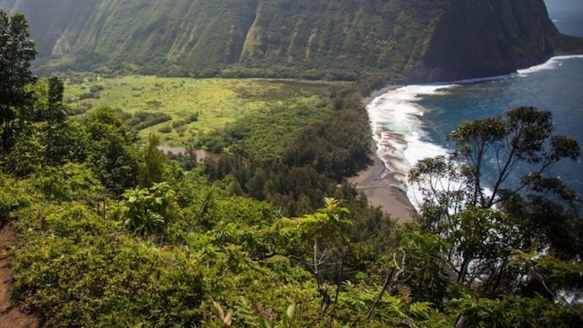 A cliff next to a beach at Waipio Valley, Hawaii A cliff next to a beach at Waipio Valley, Hawaii
