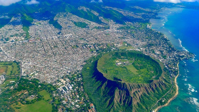A city next to a large volcanic crater and the ocean A city next to a large volcanic crater and the ocean