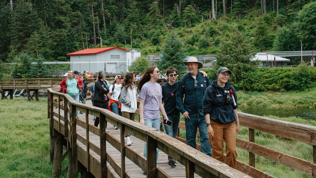 Guests walking across a wooden bridge in Ketchikan, Alaska Guests walking across a wooden bridge in Ketchikan, Alaska