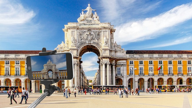 Un brazo extensible para tomar selfis y una cámara sostenida frente a la Praça do Comércio en Lisboa, Portugal Un brazo extensible para tomar selfis y una cámara sostenida frente a la Praça do Comércio en Lisboa, Portugal