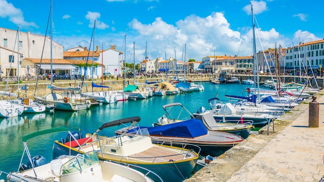 A European village next to a small marina filled with pleasure boats A European village next to a small marina filled with pleasure boats