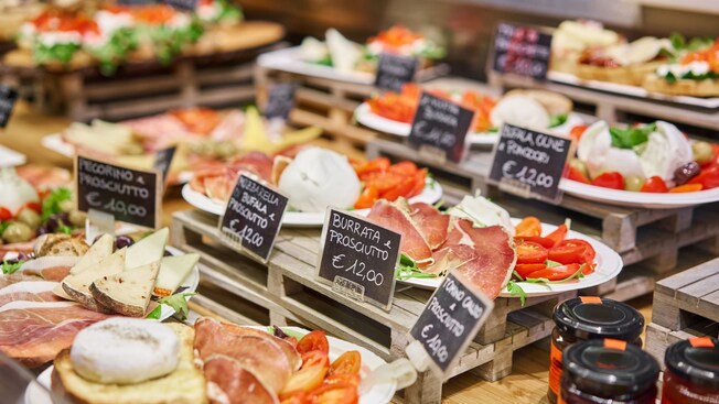 An assortment of street food offerings in Florence including different types of prosciutto
