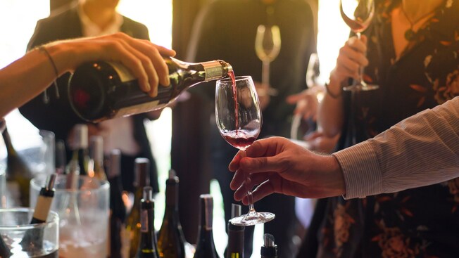 Wine is poured into a glass