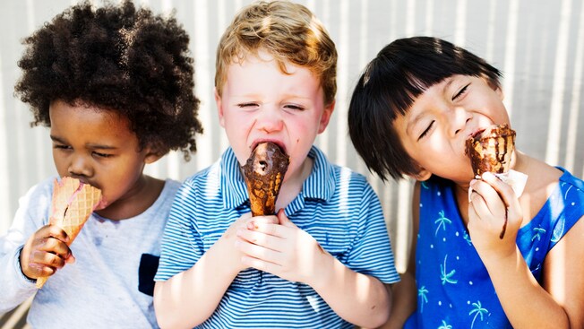 Three children eating gelato in waffle cones