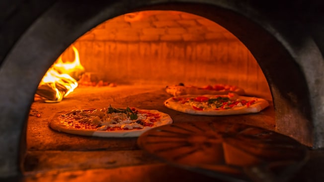 Handmade pizzas in a stone oven Handmade pizzas in a stone oven
