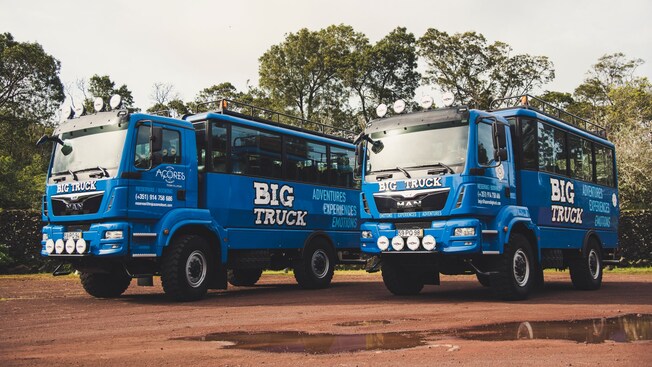 Two large trucks with tour bus style seating areas