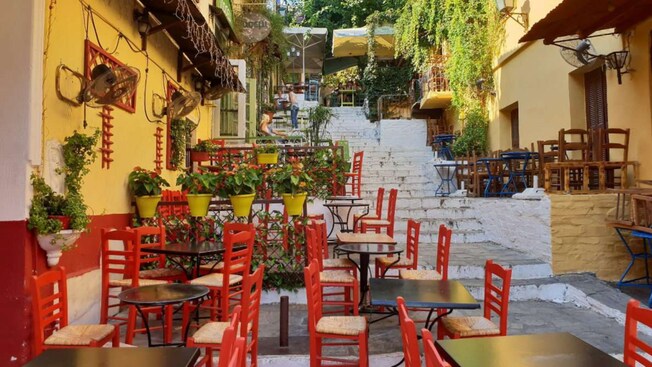 Restaurant tables and chairs in an alleyway