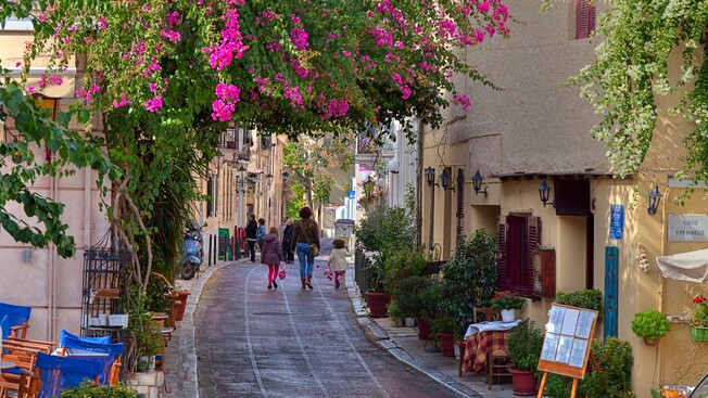 An alleyway in the neighborhood of Plaka in Athens featuring rustic buildings