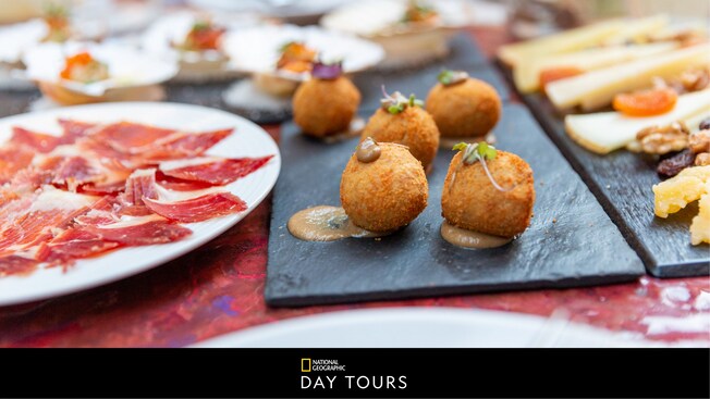 Plates filled with prosciutto, cheeses, dried fruit and other delicacies