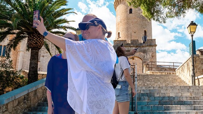 2 groups of Guests take selfies outside in Palma de Mallorca, Spain