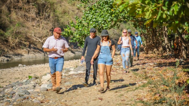 A group of people hiking along a path in the Occidental Sierra Madre