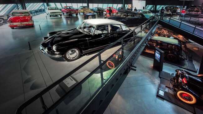 A 2 level gallery filled with an array of vintage and antique automobiles