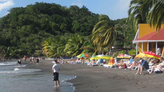 A group of people on the beach at Dominica’s Mero Beach A group of people on the beach at Dominica’s Mero Beach