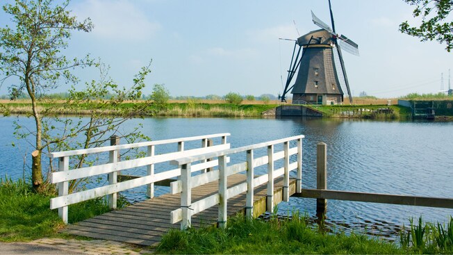 A windmill on the banks of a canal located in Kinderdijk, Holland