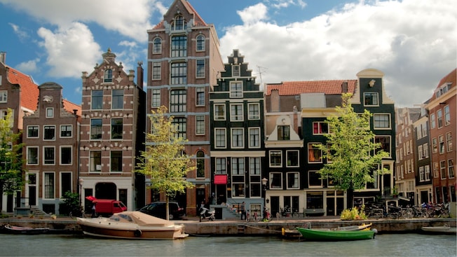 A row of Dutch style buildings along a canal in Rotterdam, Amsterdam A row of Dutch style buildings along a canal in Rotterdam, Amsterdam