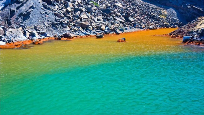 The Santorini Hot Springs alongside a rocky shore