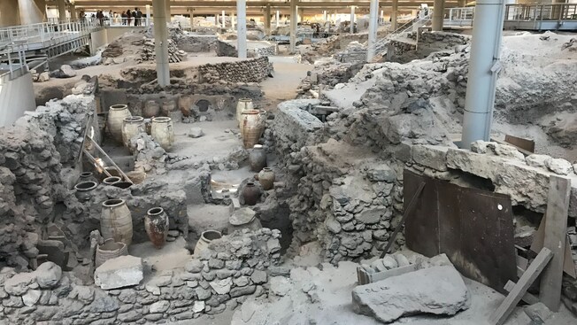 An archaeological site with ancient pots and dwellings