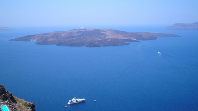 Boats navigate toward the Greek island of Santorini